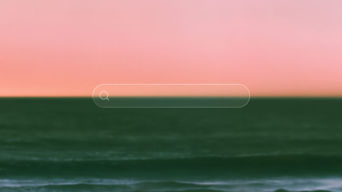 A pink sunset over a dark green sea